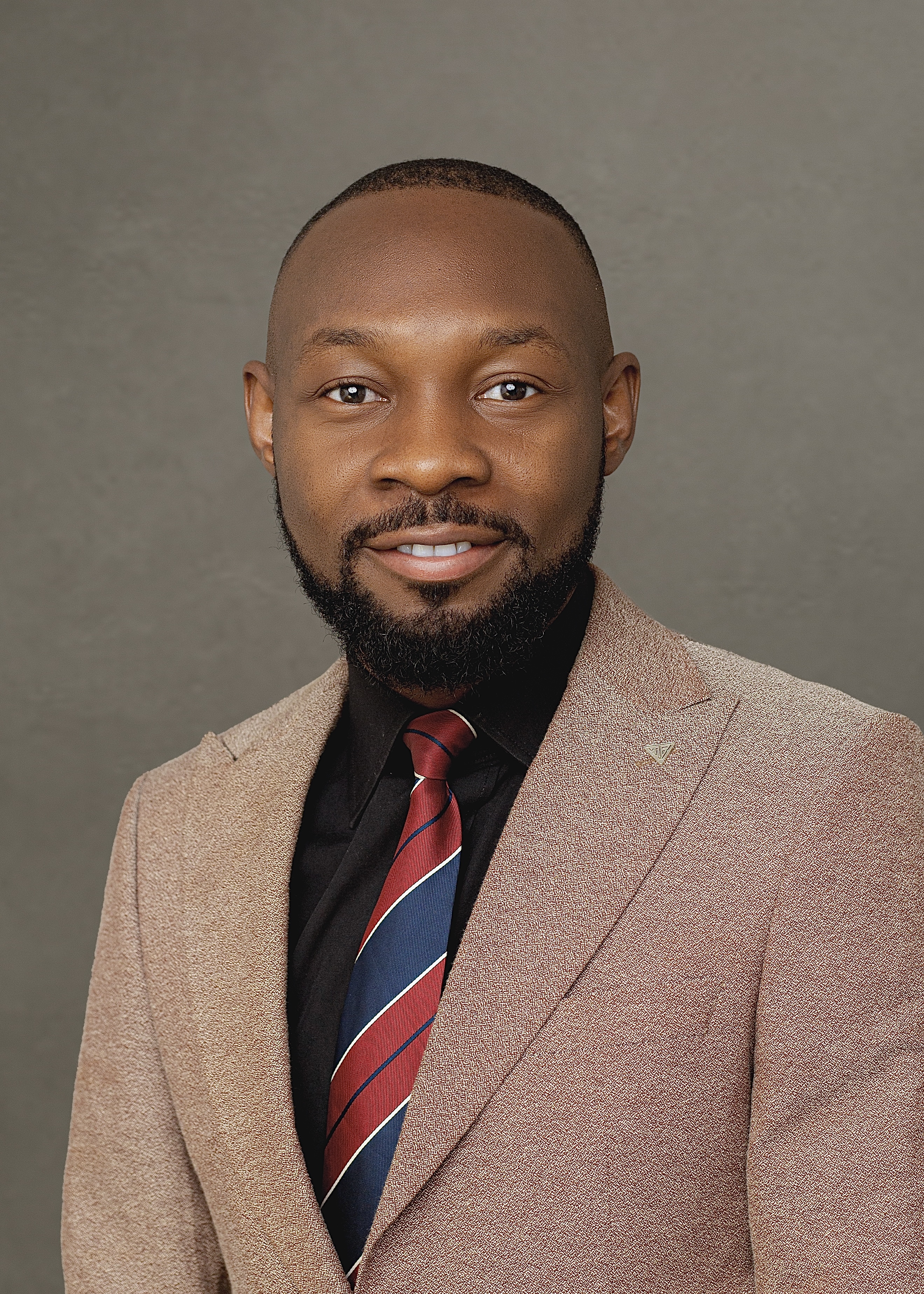 A professional headshot of Martins Ujah